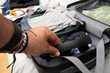 © Mandy - Person packing headphones into suitcase for travel