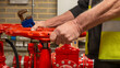 © RCH Photographic - Sprinkler system service engineer operating a red flow valve with a wrench in his hand. Wet fire safety sprinkler system being maintained by a specialist