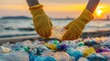 © Arfa_Media - Pollution cleanup of plastic waste on sandy beach by ocean for environment gloves