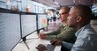 © Andrey Popov - Two Enterprise Risk Managers Use Computer Tools Analyzing Financial Data