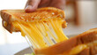 © islamamar - Person pulling apart melted cheese grilled sandwich on white bread with golden