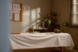 © Seventyfour - Wide shot of massage therapy room featuring treatment table, folded towels, anatomy charts, preparing for wellness session and holistic care. Ideal for spa, physiotherapy, healthcare marketing
