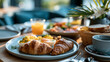 © Kateryna - A delicious hotel breakfast spread features soft eggs croissants and juice on a bright dining table in calm morning light hotel breakfast faceless still modern facility soft