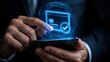 © Vasyl - Businessman's Hand Holds Modern Smartphone Interacting With Glowing Digital Credit Card For Secure Online Payment
