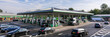 © Visual Studio - Urban Gas Station with Fuel Pumps and Vehicles - Modern Architecture in Busy Cityscape for Convenient Refueling and Travel Essentials