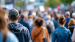 © Laura - Large group of diverse protesters marching together on a wide city road, collective social movement and civil rights concept, public demonstration, defocused urban background,