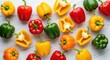 © Eka - Assortment of vibrant bell peppers displaying whole and halved forms scattered across a light surface
