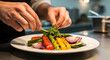 © sekar - Chef garnishing a gourmet plate of grilled vegetables with fresh herbs