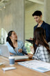 © Crystal - Group of diverse business professionals discussing project ideas and strategies during a corporate meeting in a modern workspace