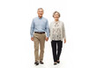© SVITLANA - Smiling senior couple walking together in bright studio lighting, cheerful lifestyle portrait