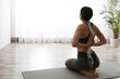 © New Africa - Woman practicing yoga indoors. Illustration of spinal column on her back