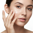 © Chanchal - Beautiful Young Woman Applying Moisturizing Cream to Her Face for Healthy, Radiant Skin