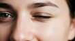 © soang - Close up of a young woman winking with natural skin texture and eyes