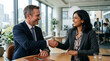 © Petra 4K Media - Smiling business professionals shaking hands over a wooden desk in a modern office setting with city view.