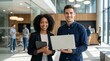 © StockSphere - Young happy professional work team of two diverse confident female and male partners employees business people man and woman standing together in office looking at camera, corporate portrait.