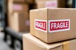 © whitestorm - Cardboard boxes with large red 'FRAGILE' stickers stacked for shipping and delivery, logistics.