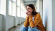 ©  VladaToday - Woman in casual attire relaxing in bright hallway with copy space; leisure lifestyle