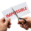 © Abdullah - A high quality Hands Cutting the Word Impossible with Scissors  Isolated on White Background.