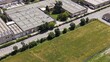 © Andrew - Industrial Park Aerial View: An expansive aerial perspective showcases a modern industrial park with various factory buildings and warehouses.