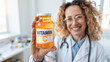 © Katerina Bond - Smiling doctor holds a vitamin C supplement jar toward the camera in a bright clinic. Selective focus.