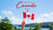 © olgakris - Canada day greeting with hand holding red white flag, maple leaf banner above blue sky, july first national holiday celebration, lakeside summer landscape, patriotic parade picnic festival