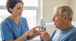 © SYATRI RAWU - Young female nurse assisting elderly male patient with breathing treatment using a medical spirometer for respiratory therapy in a hospital clinic.