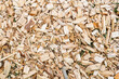 © Ilja - Close-up full frame view of a pile of wood chips, commonly used for landscaping, mulch, or biomass fuel. The chips vary in size and color, creating a textured and natural.