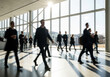 © Songpong - Business Professionals Walking In Modern Office Building With Sunlight And Glass Walls