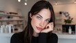 © Prapan - Elegant Portrait: A beautiful young woman with striking blue eyes and dark hair gazes calmly into the camera, her hand resting gently on her chin, exuding a serene and thoughtful presence.