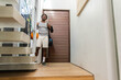 © wavebreak3 - Standing adult male in sportswear holding orange basketball, carrying black gym bag at modern foyer