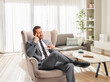 © Ljupco Smokovski - Pensive man in a suit sitting in an armchair