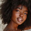 © Penyol Puyol - Beautiful Young Black Woman with Curly Hair and Radiant Smile.