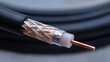 © intha - Close-up of coaxial cable with copper conductor and braided shielding for telecommunications and signal transmission, network infrastructure, and communication systems concept.