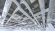© Jack - The installation of an industrial HVAC system with a number of large rectangular ducts and pipes on the ceiling is necessary for the ventilation and climate control of a modern building interior.