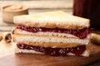© New Africa - Tasty sandwiches with peanut butter, jam and nuts on table, closeup