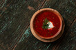 © Alona Dudaieva - Traditional Ukrainian borscht soup with sour cream and dill in a clay bowl