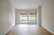 © ADDICTIVE STOCK - Empty modern room with sliding glass door and balcony