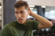 © New Africa - Tired man sweating after workout in gym