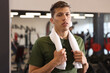 © New Africa - Tired man with sweat on his body and towel after workout in gym