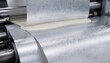 © DigitalSpace - Closeup medium shot of matte flexible laminate extrusion process molten polymer layered onto foil web emphasizing textured nonreflective surface ideal for minimal glare packaging.