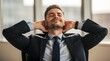 © Sajidh - Businessman relaxes in his office chair with hands behind his head while feeling satisfied and proud of his recent career achievements.