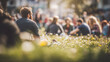 © dhea - People celebrate May Day in a sunny outdoor field with onlookers.