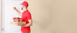 © Pixel-Shot - Handsome worker of food delivery service knocking at the door