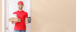 © Pixel-Shot - Handsome worker of food delivery service with mobile phone near customer's door