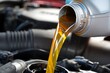 © designer rofiqul - Golden motor oil pouring from silver bottle into car engine image