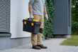 © MonkeyZ - Man Holding Toolbox Ready For Work Or Home Improvement Tasks