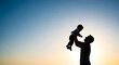 © Mohshin - Silhouette of a father lifting his baby son against sunset sky