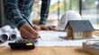 © Wayyu - Architectural Design and Planning Process with Blueprints and Model House.