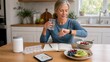 © Maryia - Women preventive health routine with mature woman tracking wellness habits at breakfast, showing midlife self care, hydration and proactive daily health management.