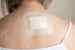 © Sarolta Nagy - postoperative bandage after skin lesion removal on upper back